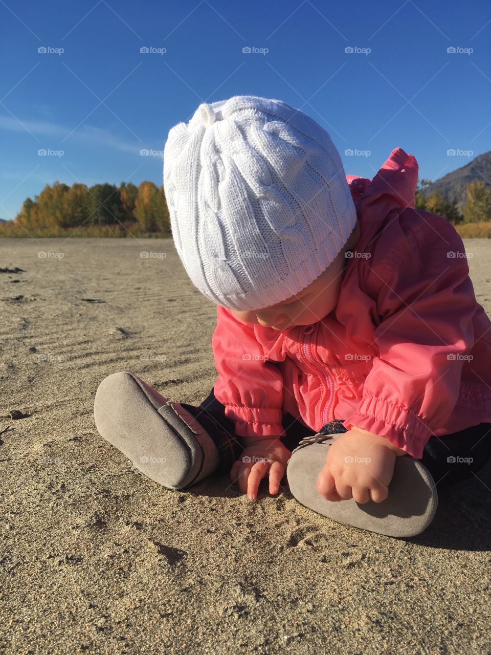 Infant playing in the sand