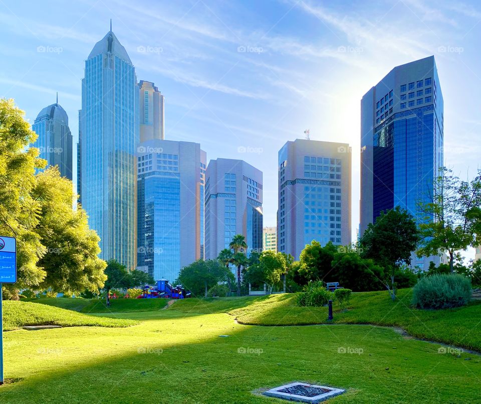 Blue sky and modern buildings, blue shiny sky and stylish modern buildings, park and blue sky, city park with blue sky
