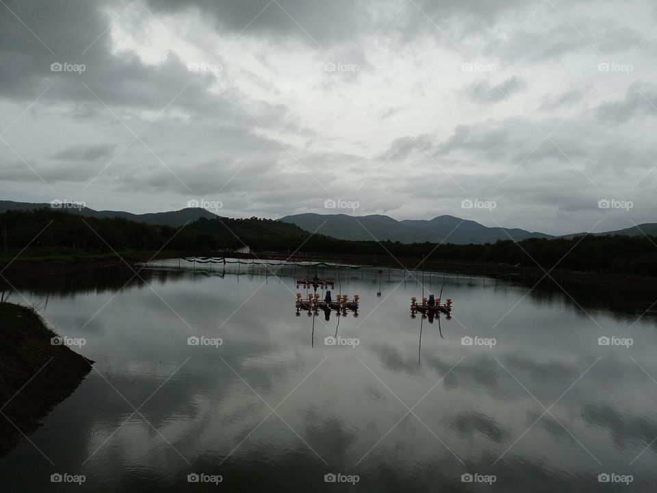 rainy cloud in sky reflected in river evening time beautiful view of nature mountain landscape village side