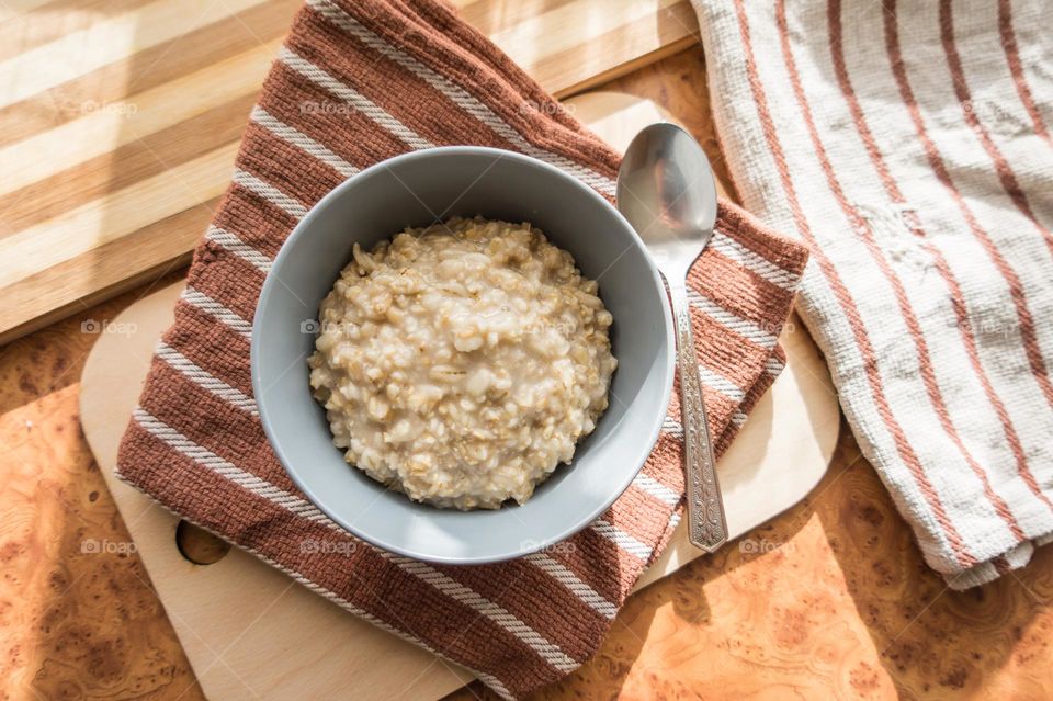 Cooked oatmeal in a deep gray plate.
