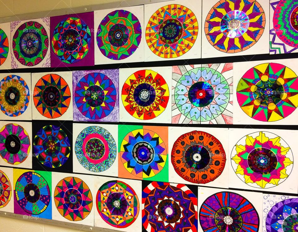 Children’s radial symmetry art work with colorful cd’s and colored pencil