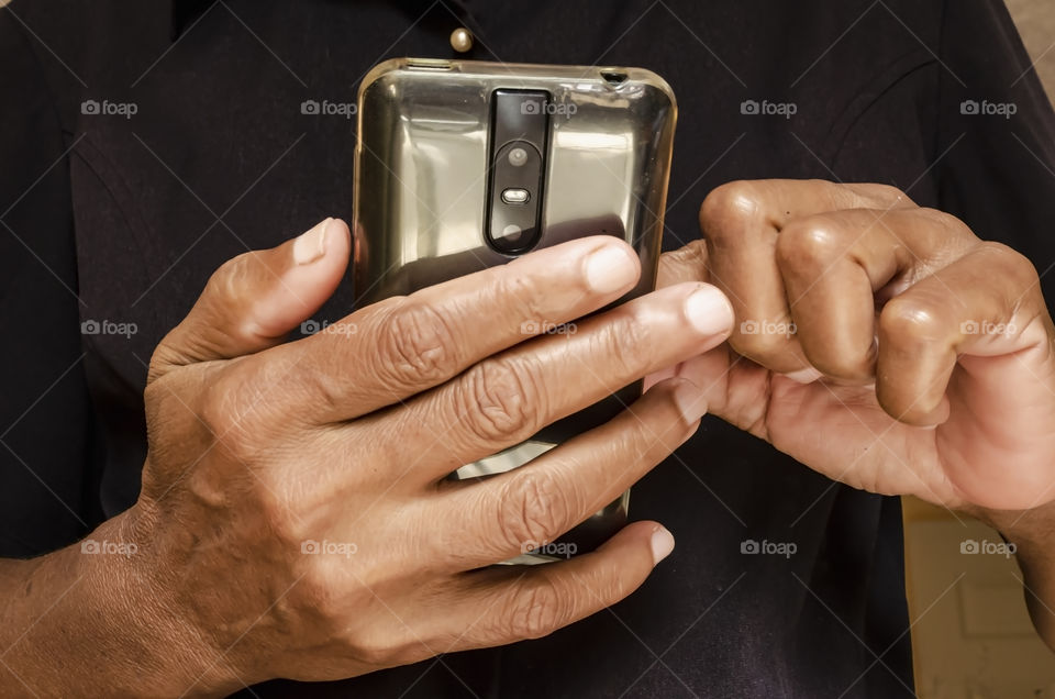 Hands Of Woman Using Mobile Phone