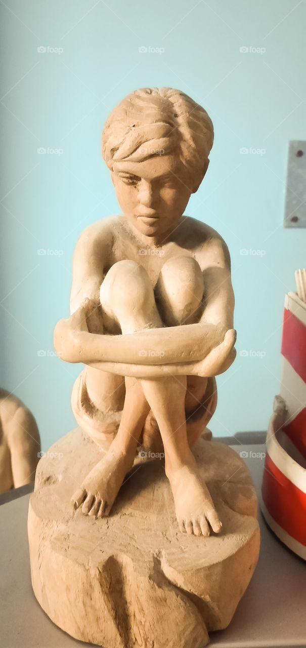 a sitting boy  statue