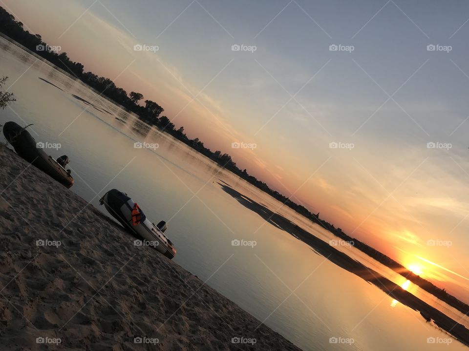 Inflatable boats at sunset.  River and sunset. Russian nature. 