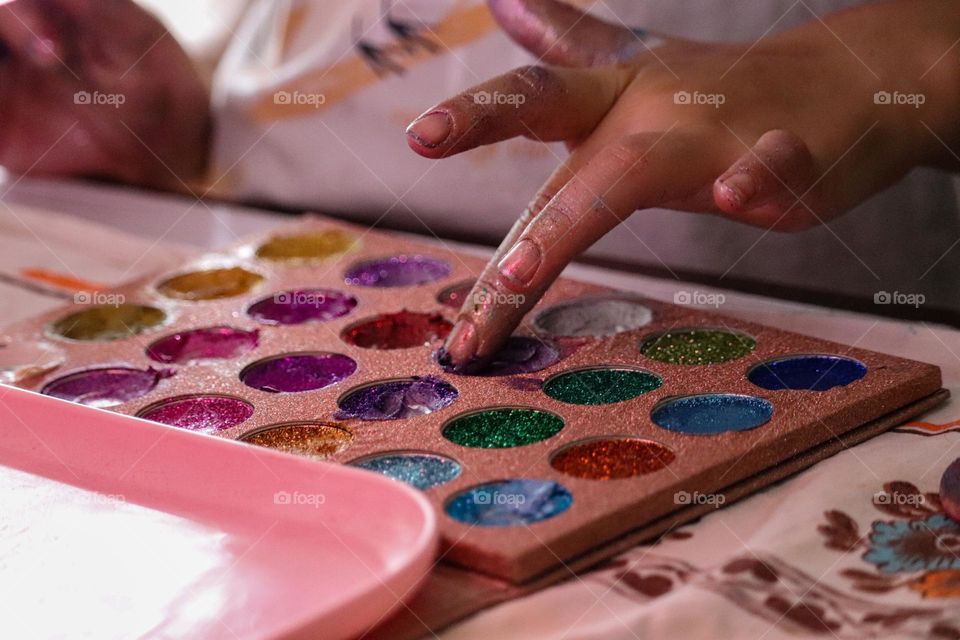 Playing with the glitter - putting on a make up