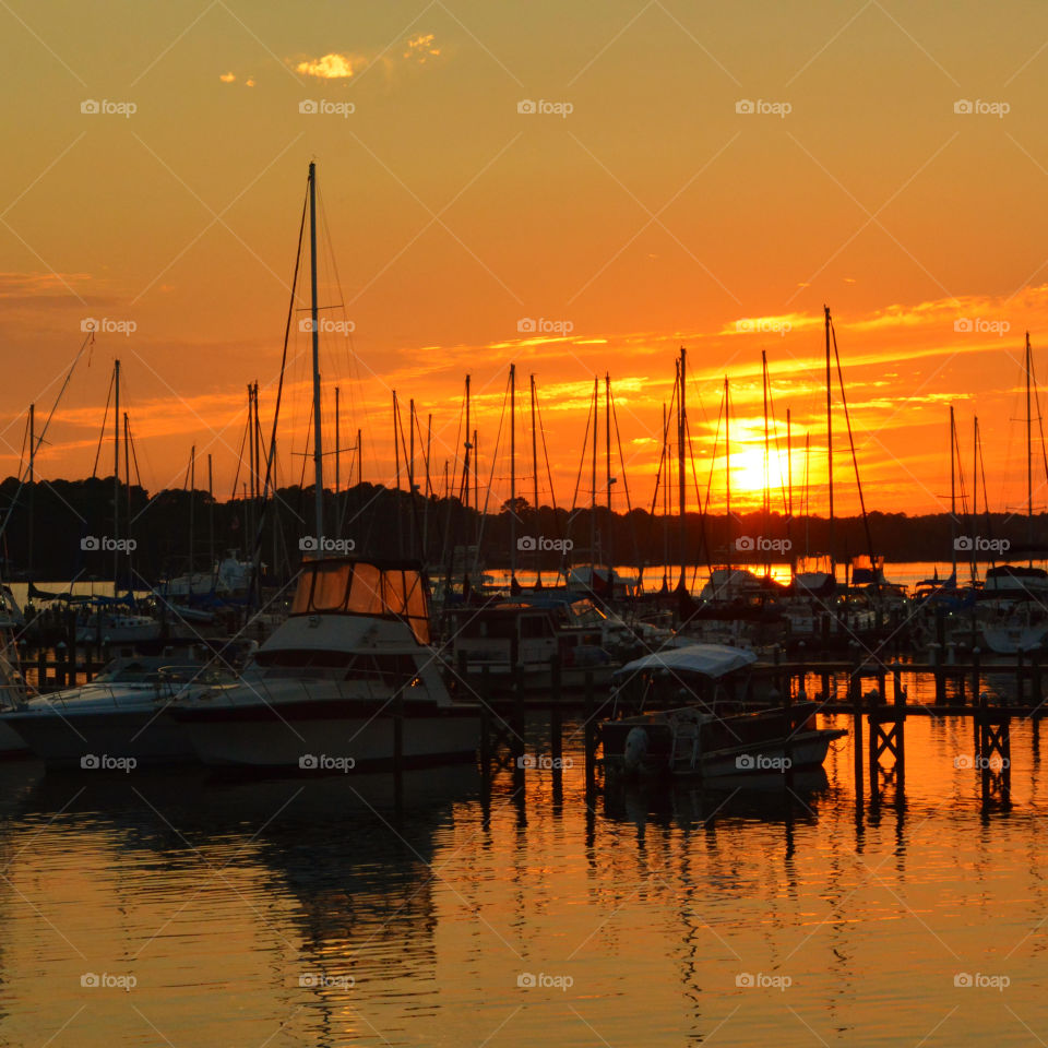 Sailboat reflecting in sea