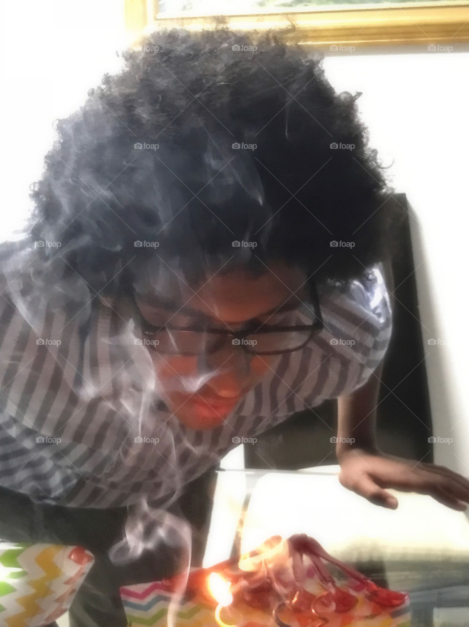 Indian man blowing a cake