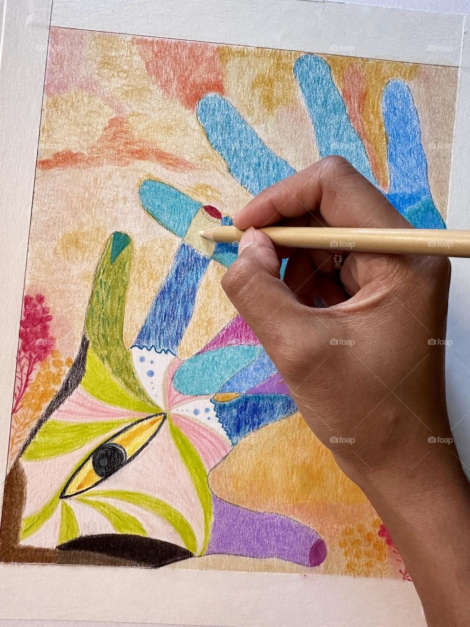 Close up of woman’s hand making art or drawing a colorful two hands in different perspectives.