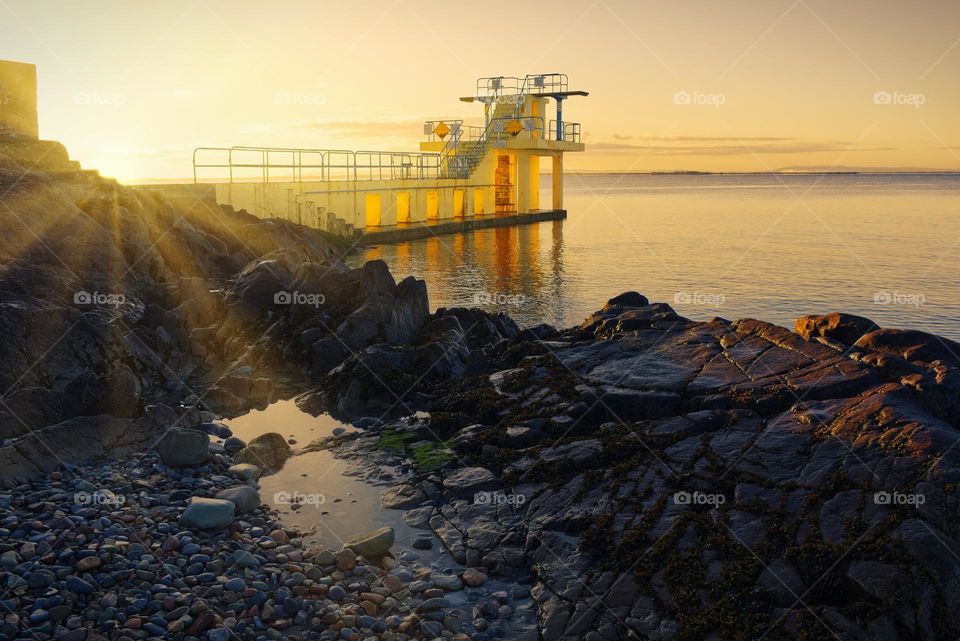 Sunrise at Blacrock diving tower on Salthill beach in Galway, Ireland
