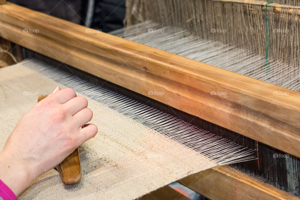 Woman working on loom