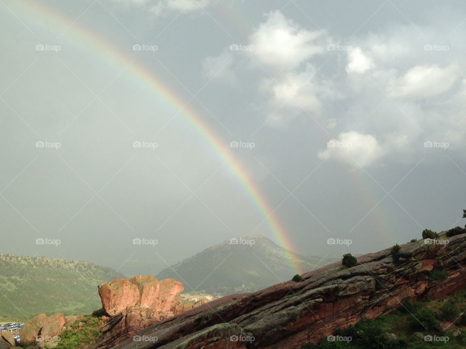 View of rainbow in sky from mountain