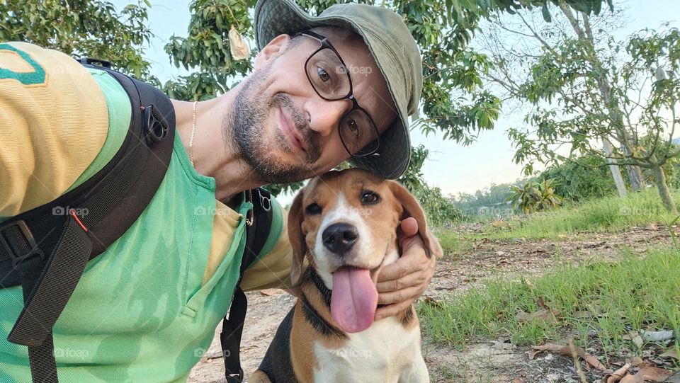 Nice smiling guy with his cute beagle dog