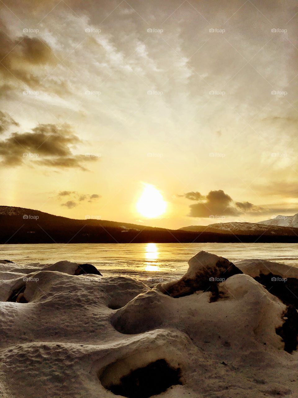 Sunset on icy lake 