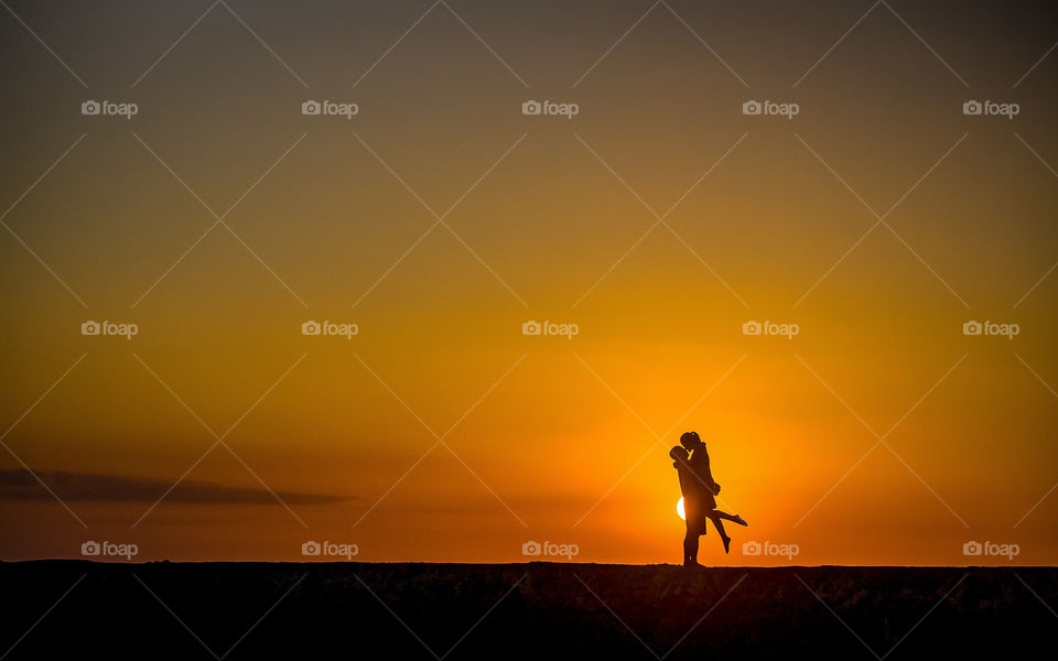 Silhouette of couple at sunset