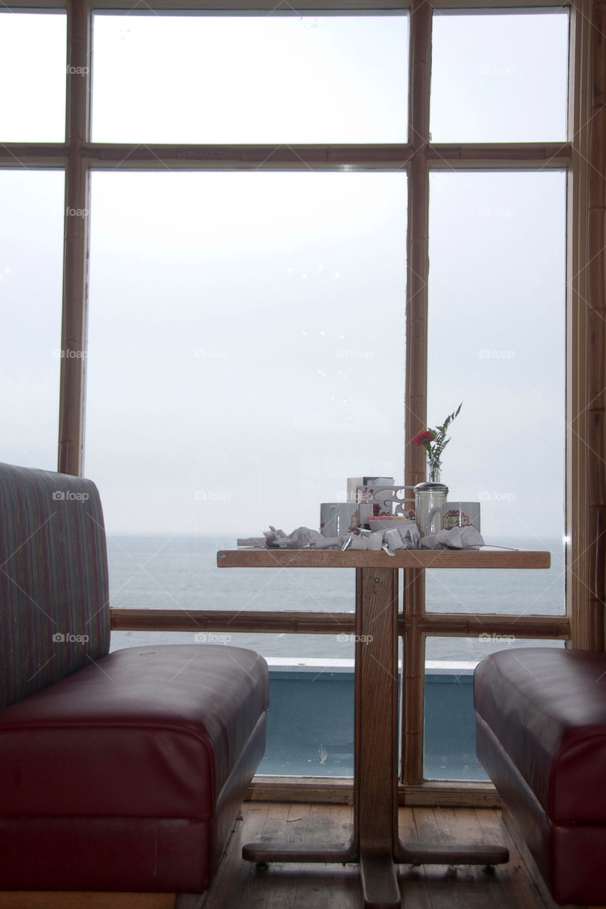 A booth by the window on the pier overlooking the ocean