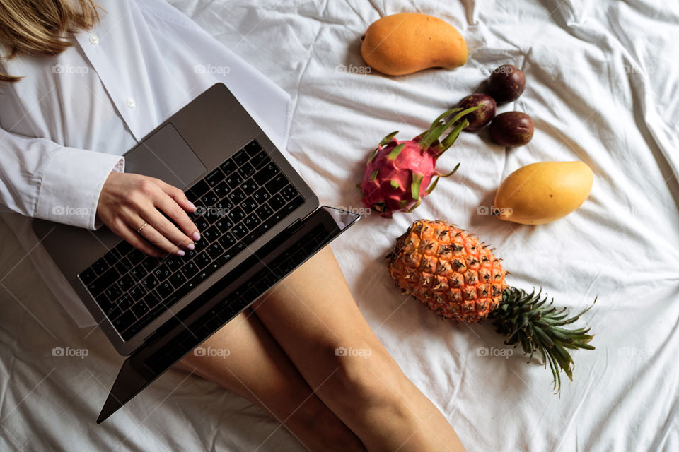 Blogger girl using laptop on the bed