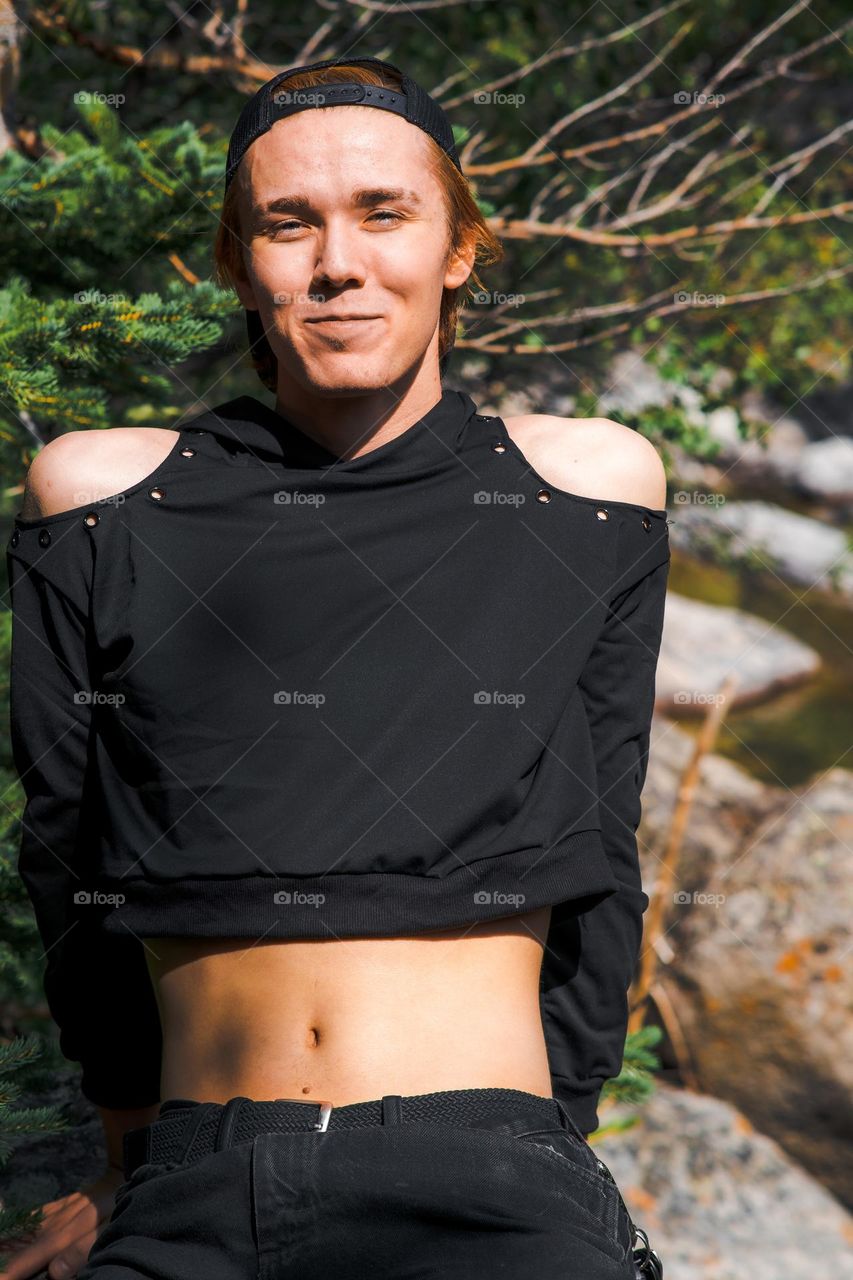 Portrait next to the rocky river.