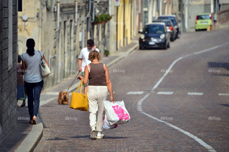 a woman walking on the street after shopping