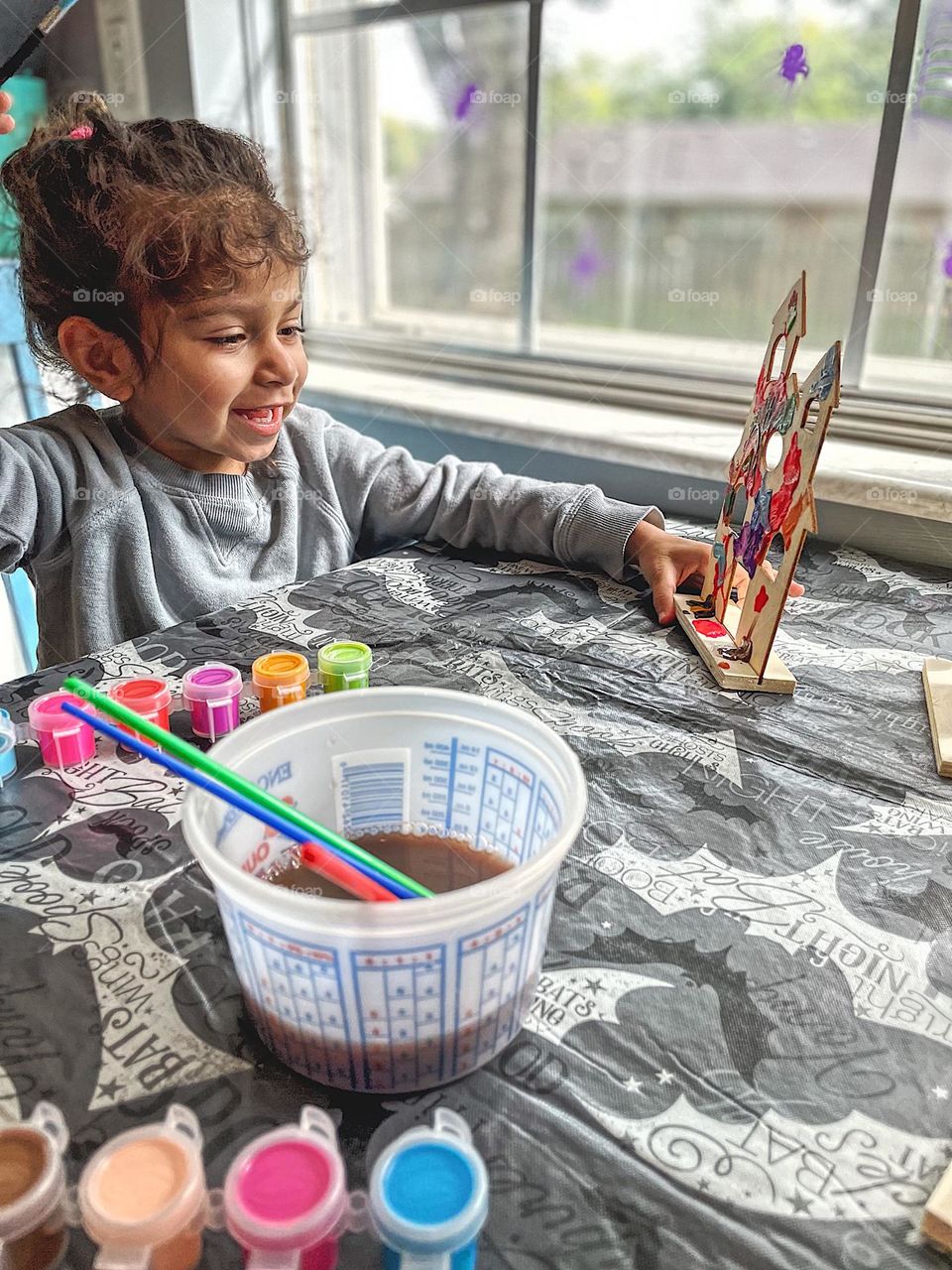 Toddler girl paints haunted house for Halloween, fun with crafts for Halloween, painting for the holidays, toddler girl does crafts, crafts with kids, being creative with kids, making messes with kids 