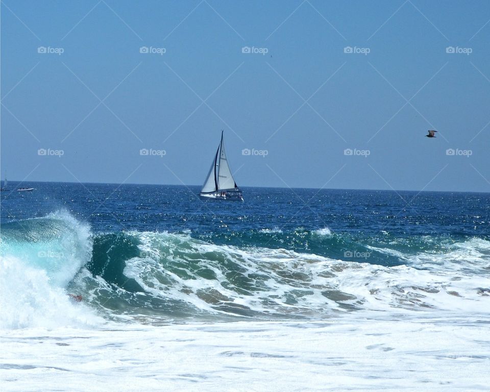 Sailing Escape. A gently breeze guides this sailboat off into distant shores.