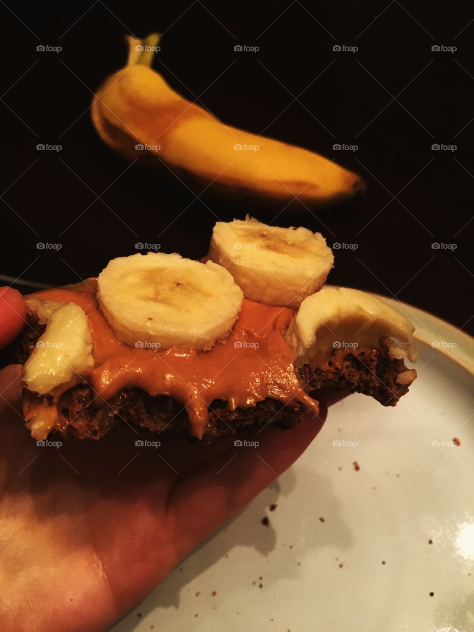 Eating peanut butter and banana on toast.