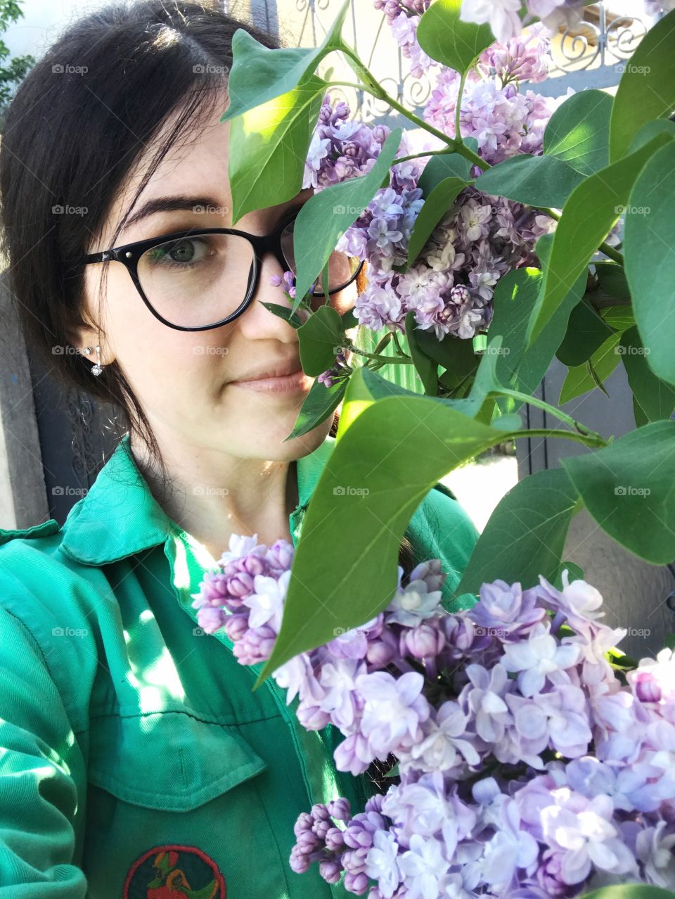 Beautiful girl portrait with a lilac flower