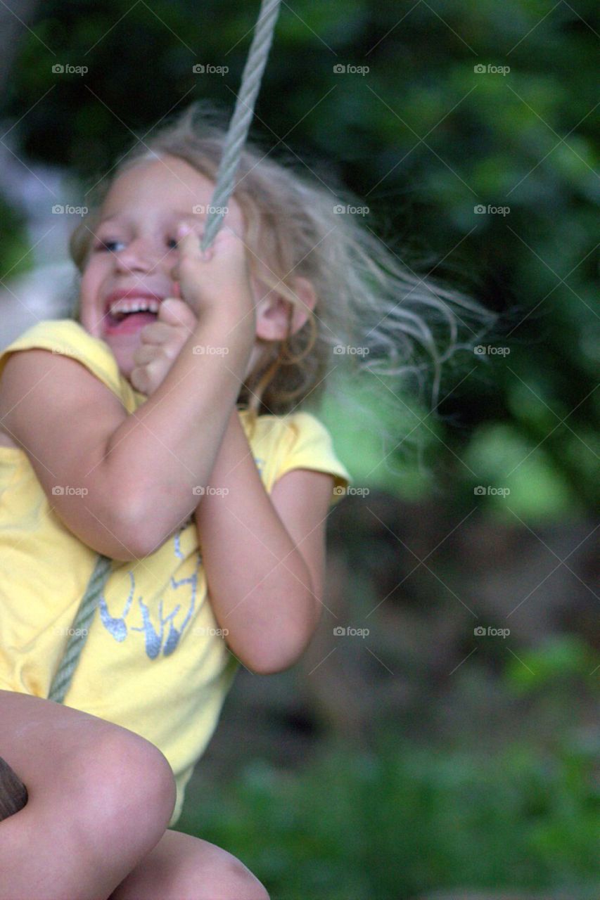 Girl enjoying on rope swing