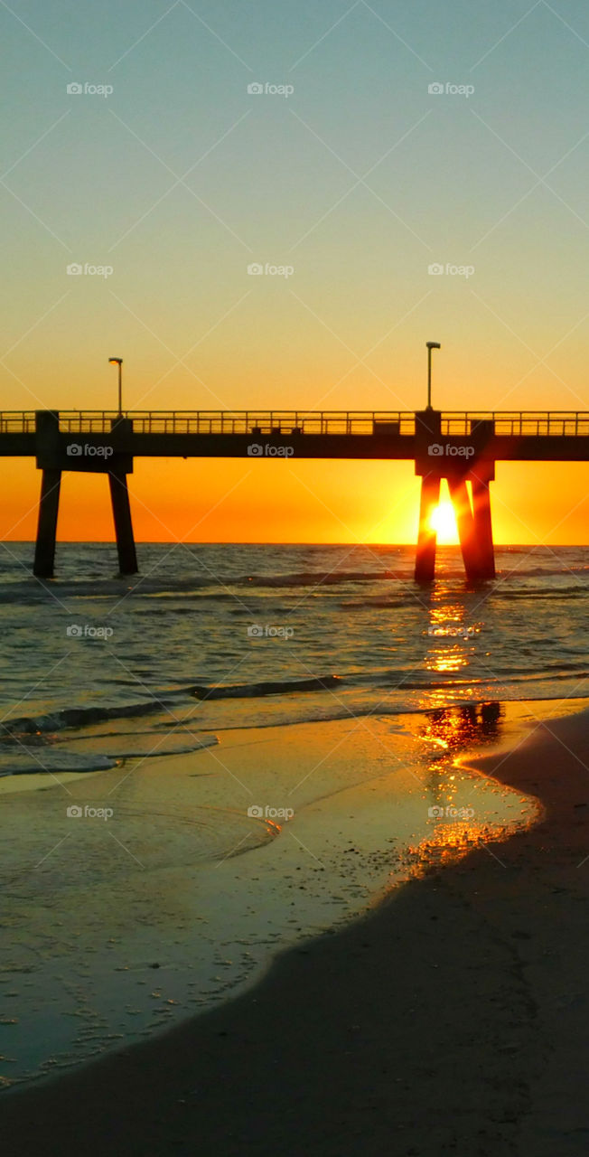 Sunset under the pier!
Stunning sunset in the Gulf of Mexico radiating explosive sun rays across the ocean and sandy beach!