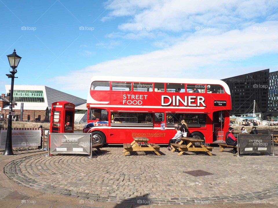 Diner food truck next to the seaside on a bright day in sunny, lively Liverpool.
