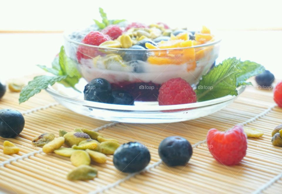 Smoothie Fresh Fruits Bowl - raspberry, blueberry,  mango, nuts and basil seeds