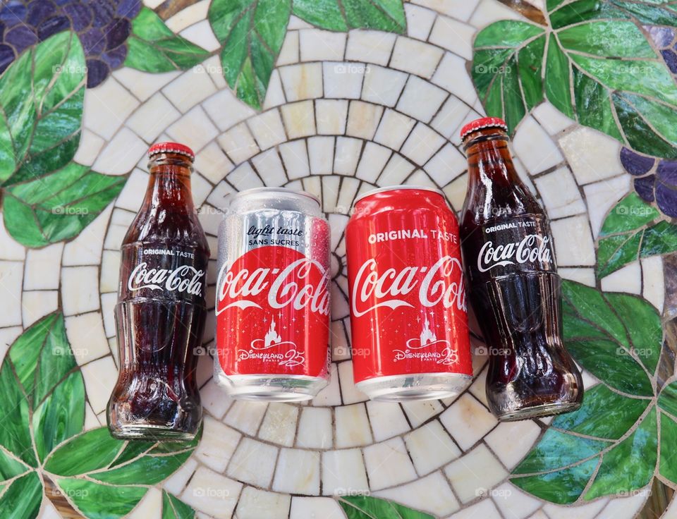 Coca Cola bottles on garden table.