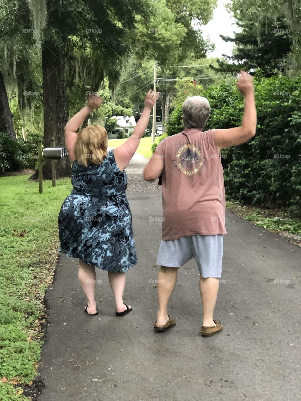 Father and daughter dancing in the street just because