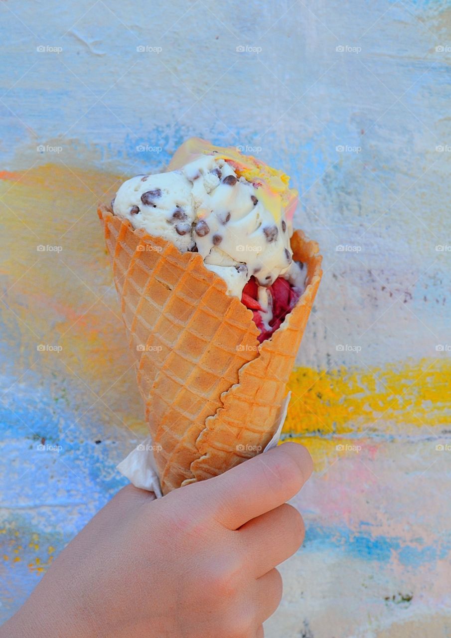 Ice cream fun. Hand holding ice cream