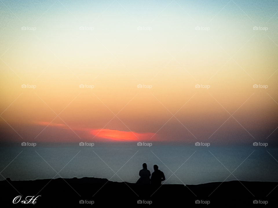 The picture bears the spectrum of two lovers sitting on a beach on the island of Djerba, the moment of sunset, in harmony with nature