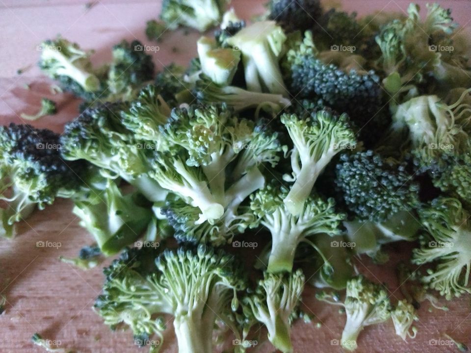broccoli freshly chopped on wooden cutting board