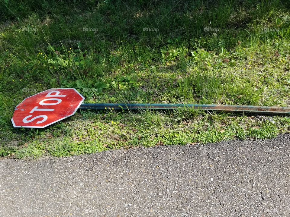 Fallen stop sign.  Supposed to be upright!