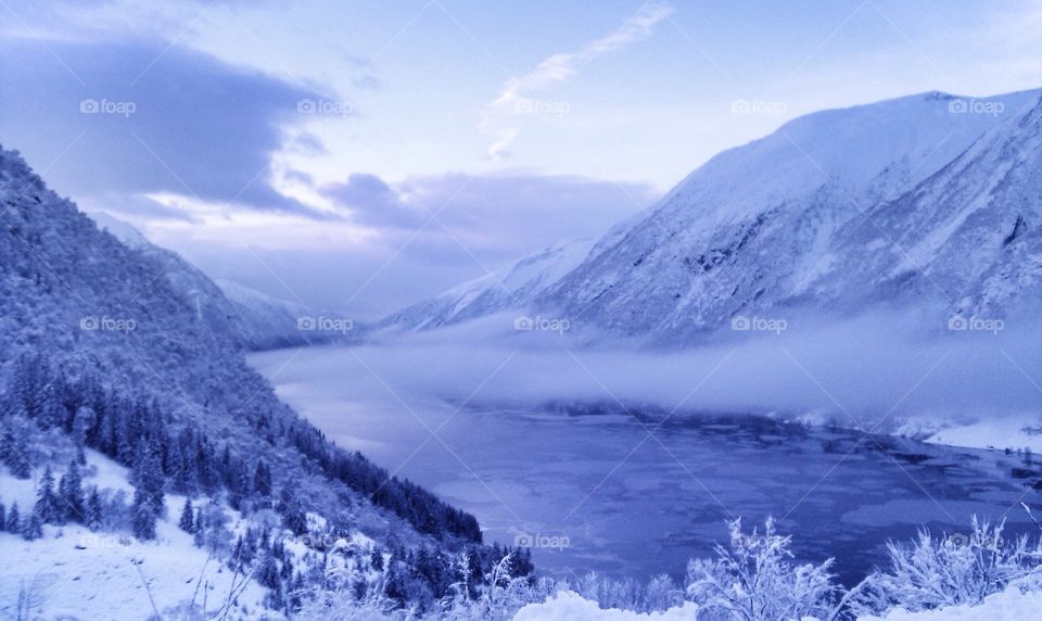 Scenic view of ice floe on river and mountains
