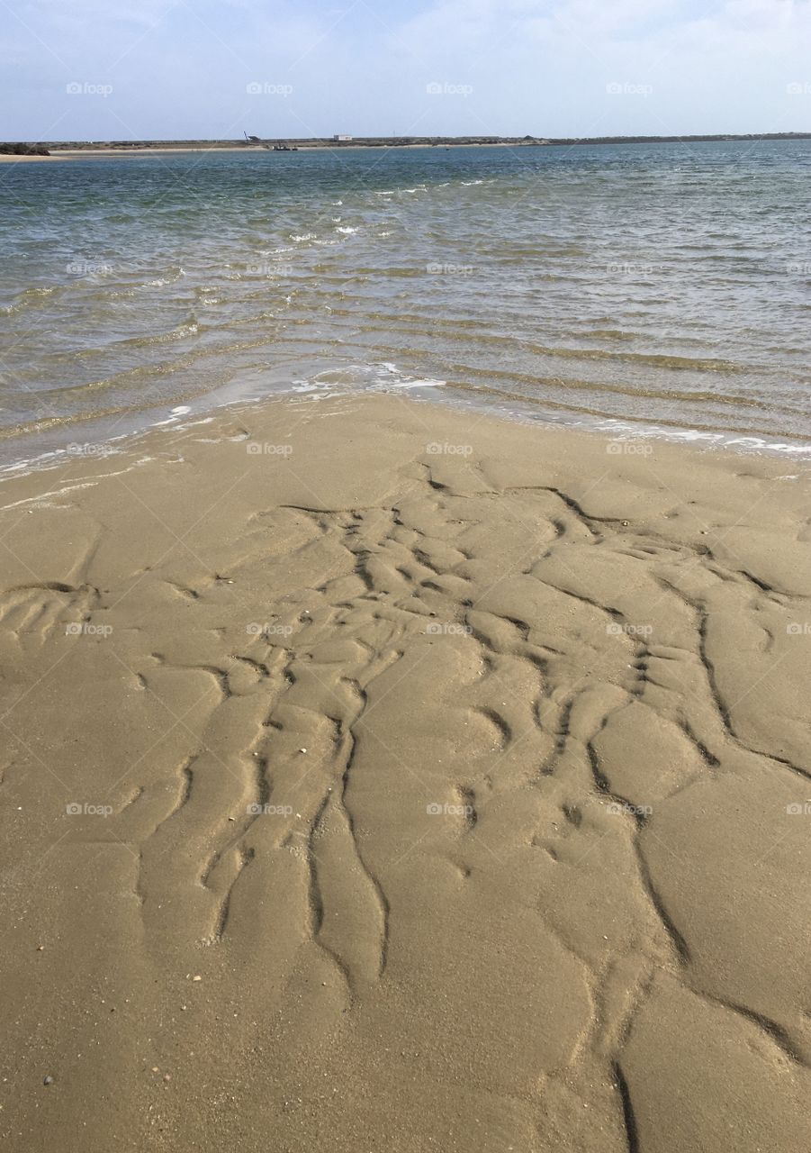 Water and sand for natural drawings on beach