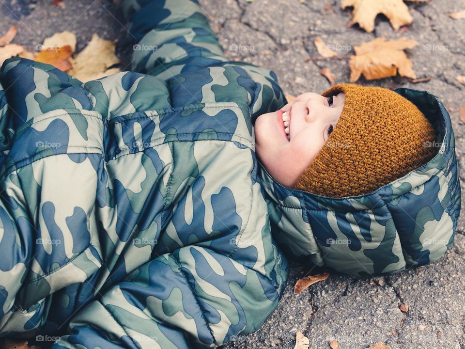 Smiling little boy in autumn clothes