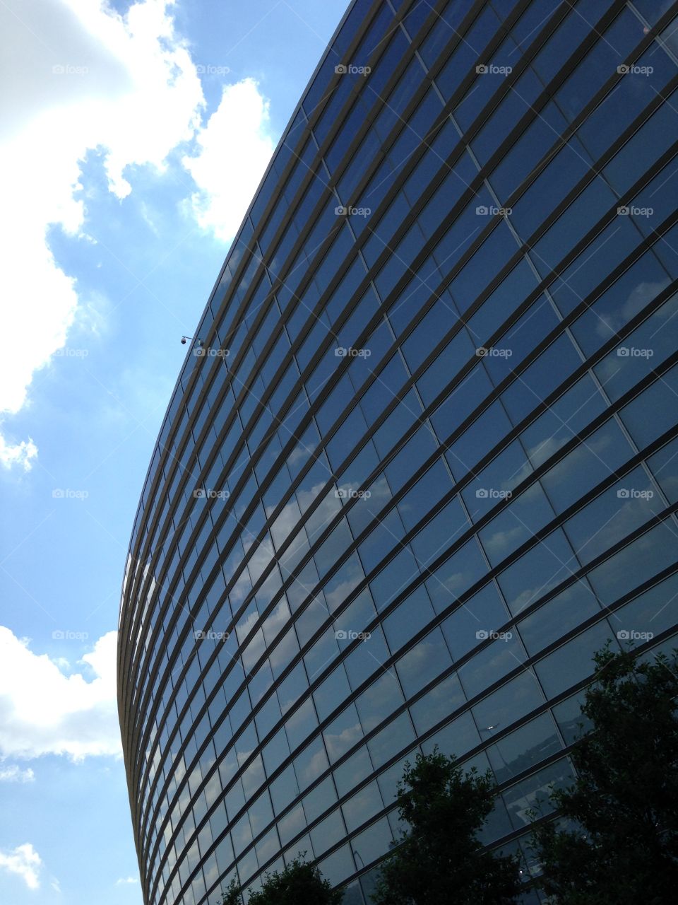 Reflecting View . Stadium windows reflect the clouds. 