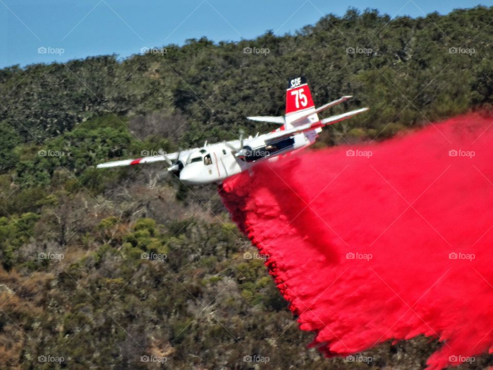 Aerial Firefighting. Aircraft Dropping Chemical Retardant On A Forest Fire
