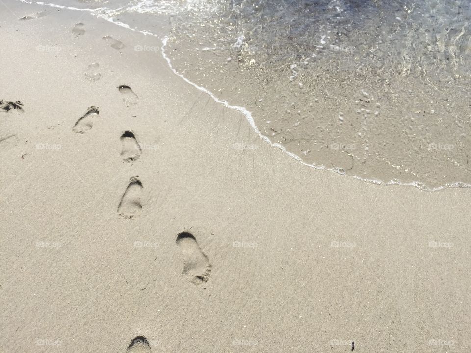 High angle view of footprints in sand