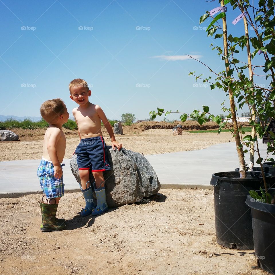 Brothers. Helping daddy plant trees, taking a break to make eachother laugh.