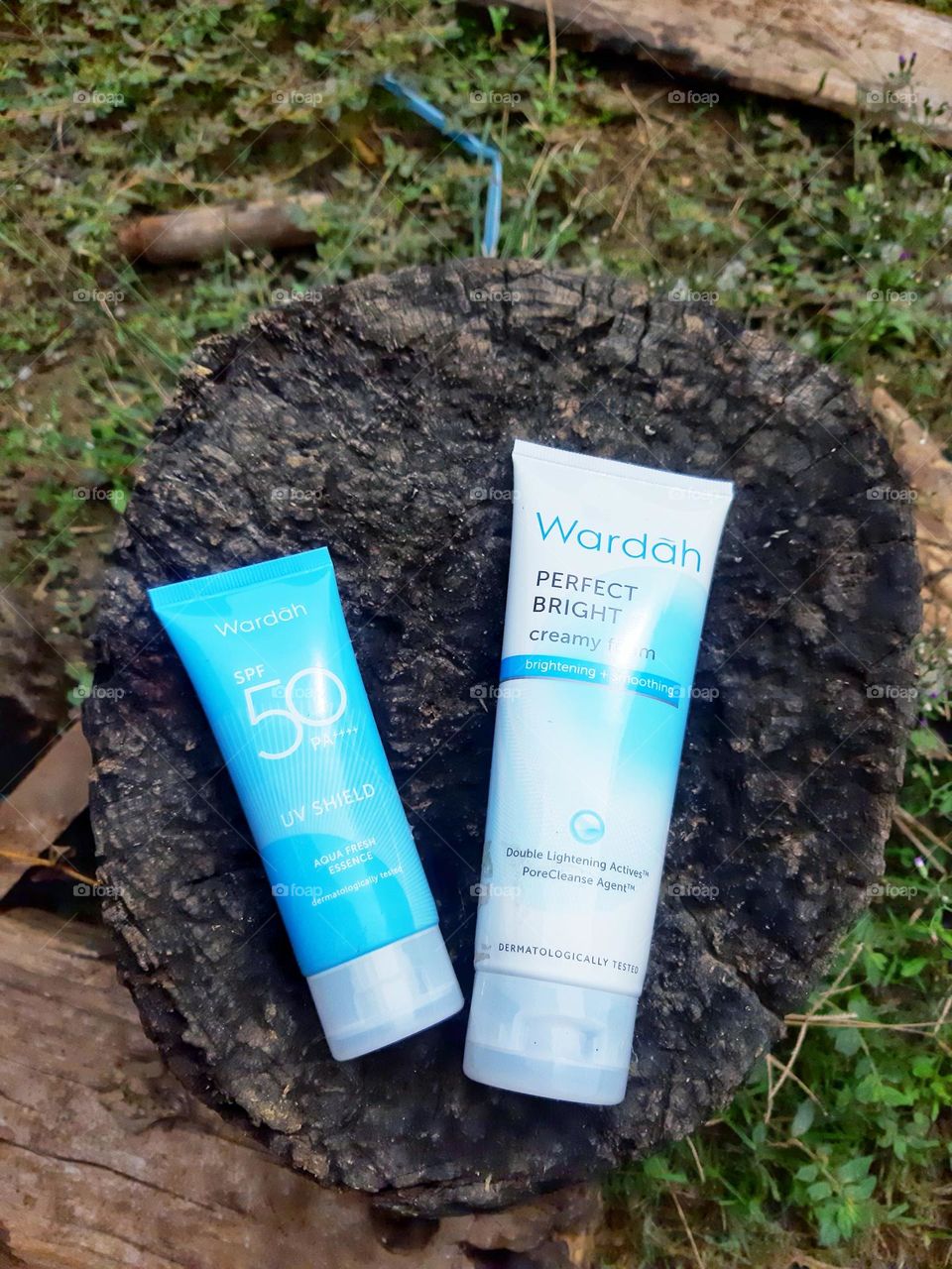 Cream products, facial lightening soap and face shield from the sun on a piece of wood