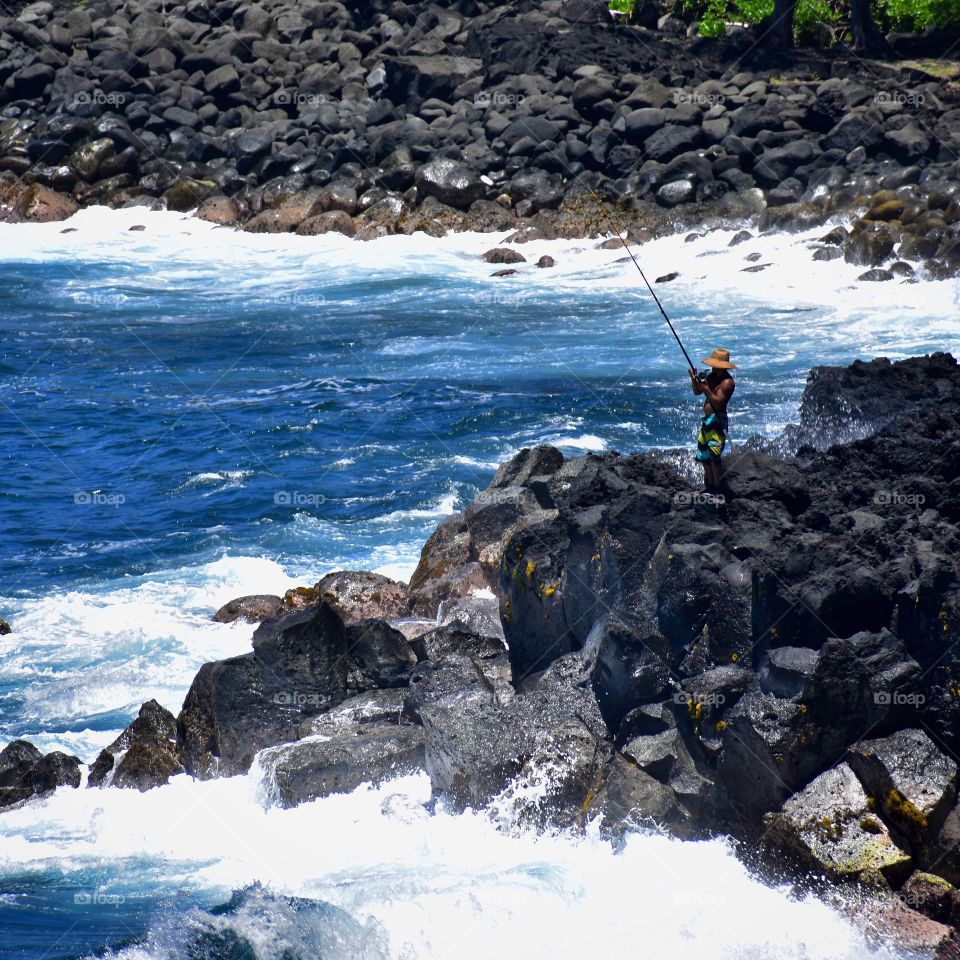 Fisherman on the lava rock just of Government Beach Road on the island of Hawaii 