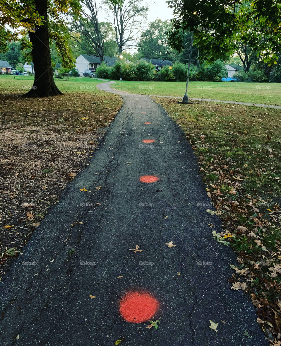 A quiet walk through a school playground, after kids return from a long pandemic lock-down. They stand 6 feet apart, waiting for the swings. 