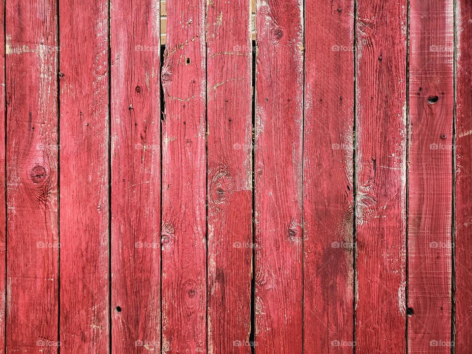 Distressed painted barn red wood slats.