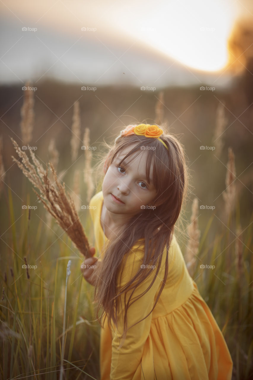 Little girl in yellow dress outdoor portrait 