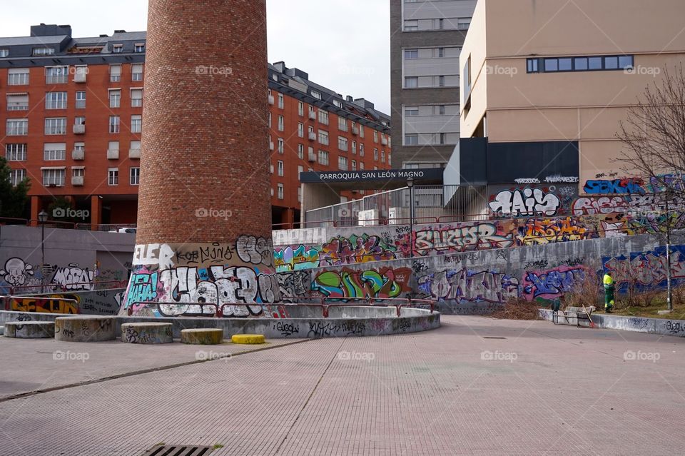 Graffiti around the base of an old smokestack, Jardín del Rastro, Madrid 