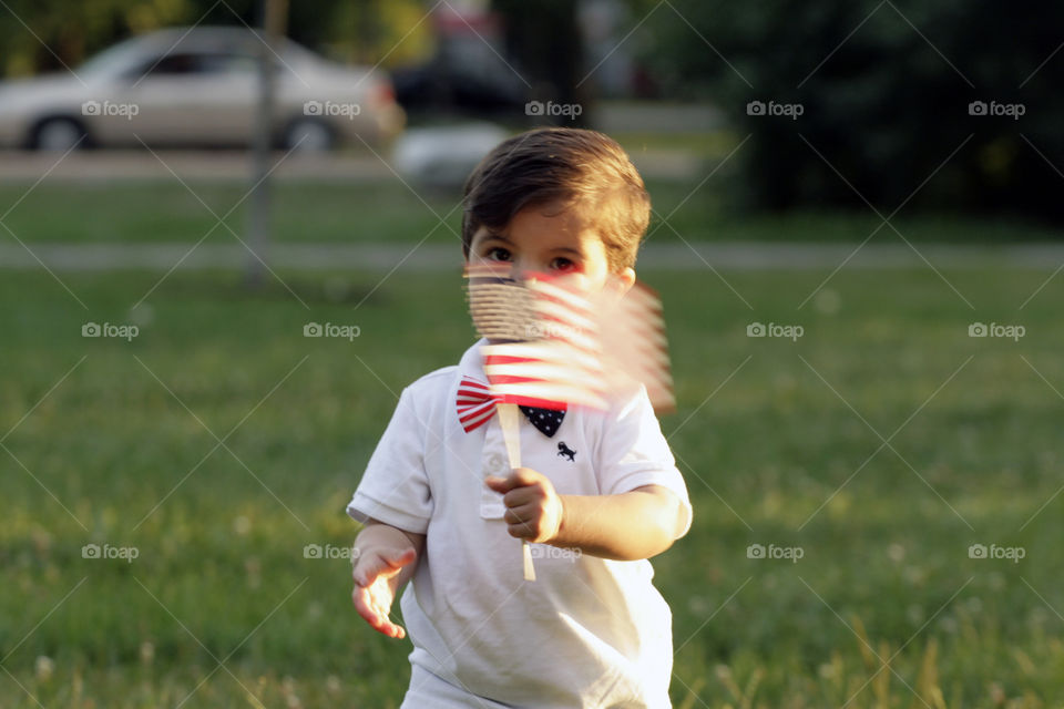 Toddler waving American flag